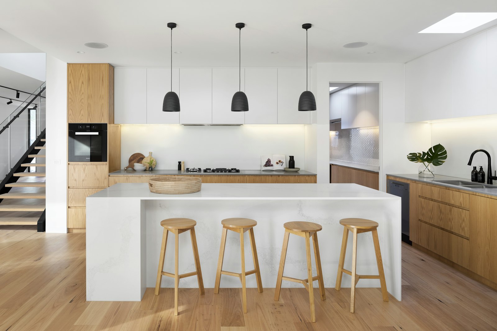 Dining area beside tall windows and a pale dining table